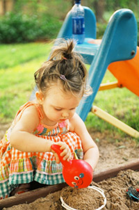 girl playing in sandbox